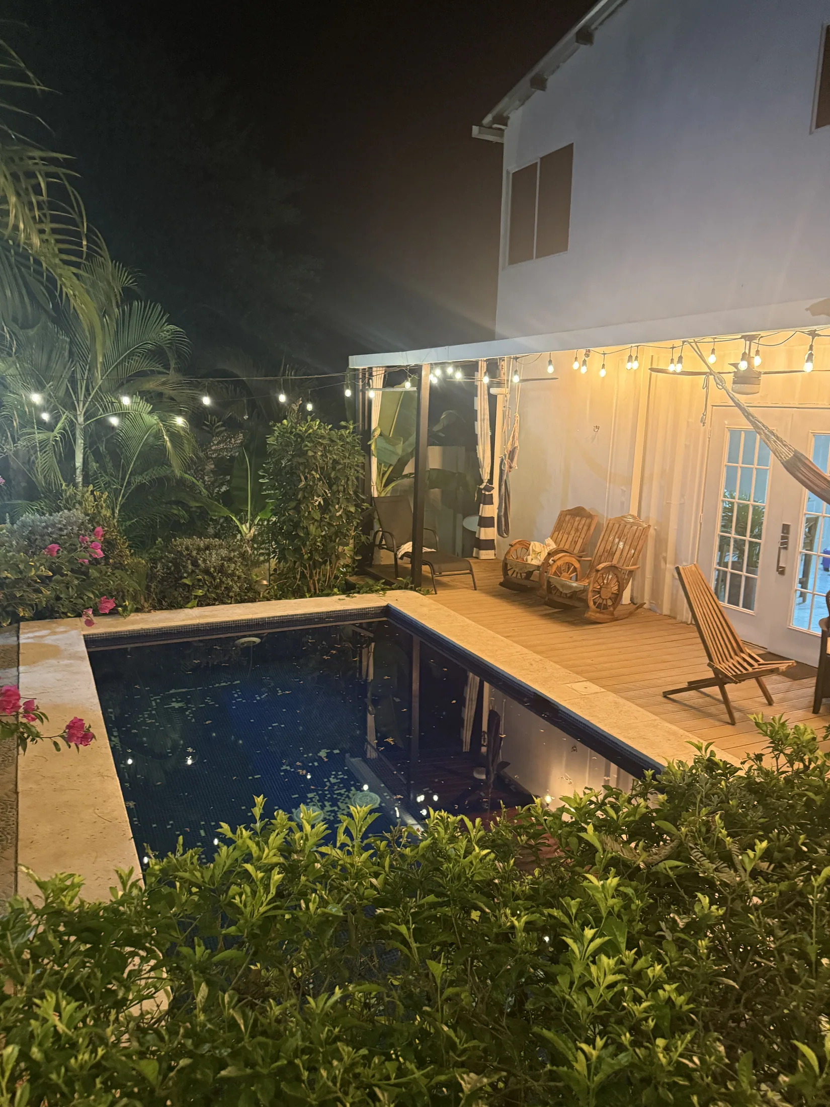 Pool and covered patio at night